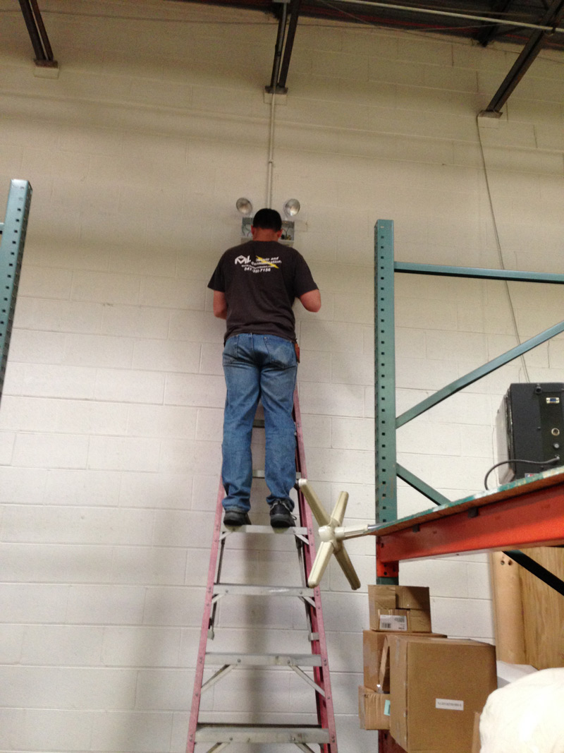 Electrician installing Chicago approved emergency light